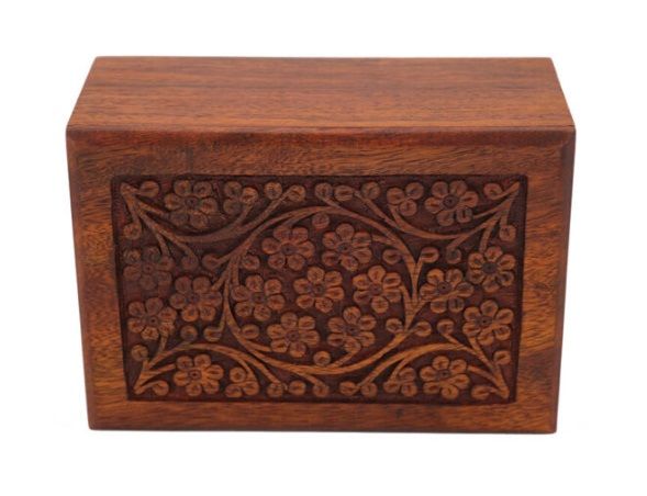 Wooden urn with floral carvings.