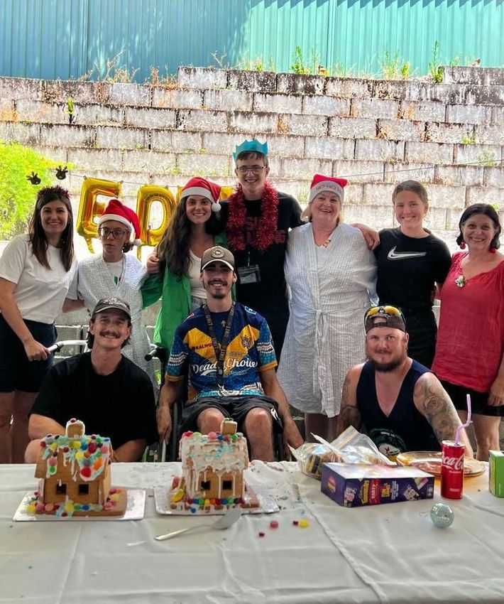 A group of people are posing for a picture at a christmas party.