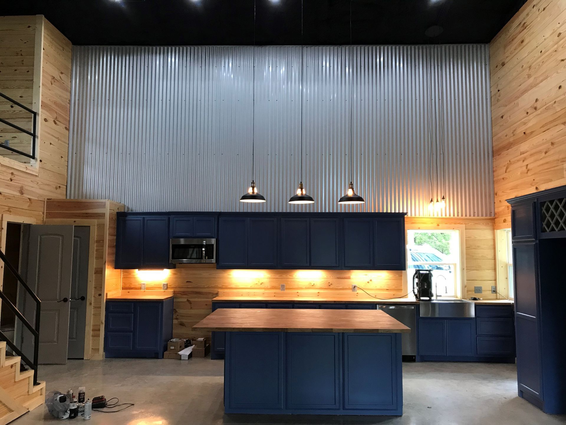 A kitchen with blue cabinets and a large island.