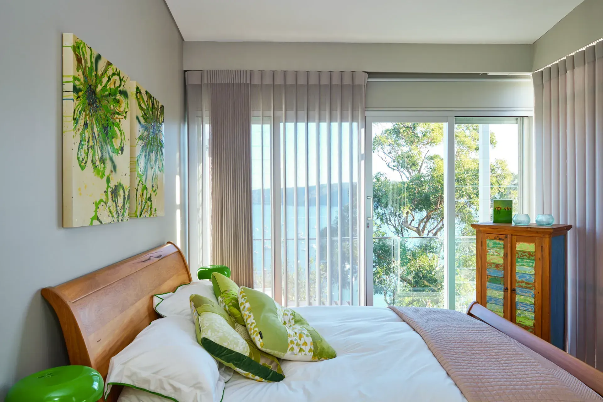 Beige curtains framing a bright window with sheer white curtains. Two teddy bears sit near the right side.