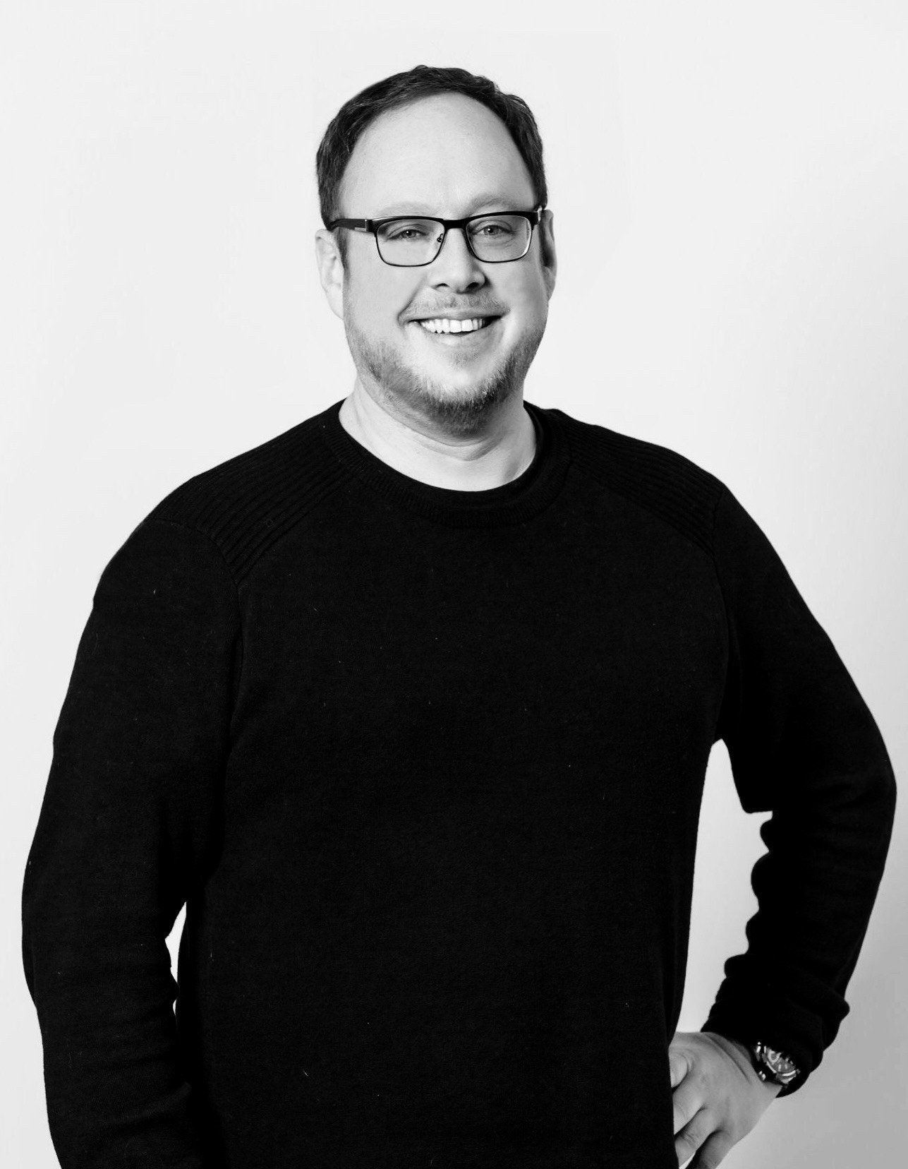Justin Fifield — Senior PPC Specialist, smiling in a black sweater