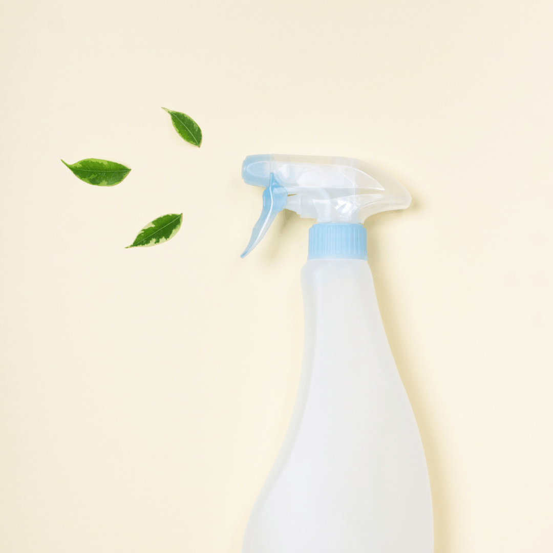 Plastic spray bottle with small green leaves emanating from opening