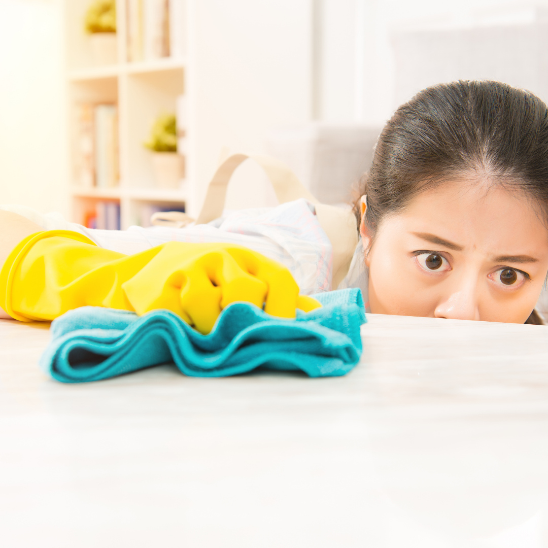 woman cleaning table surface carefully