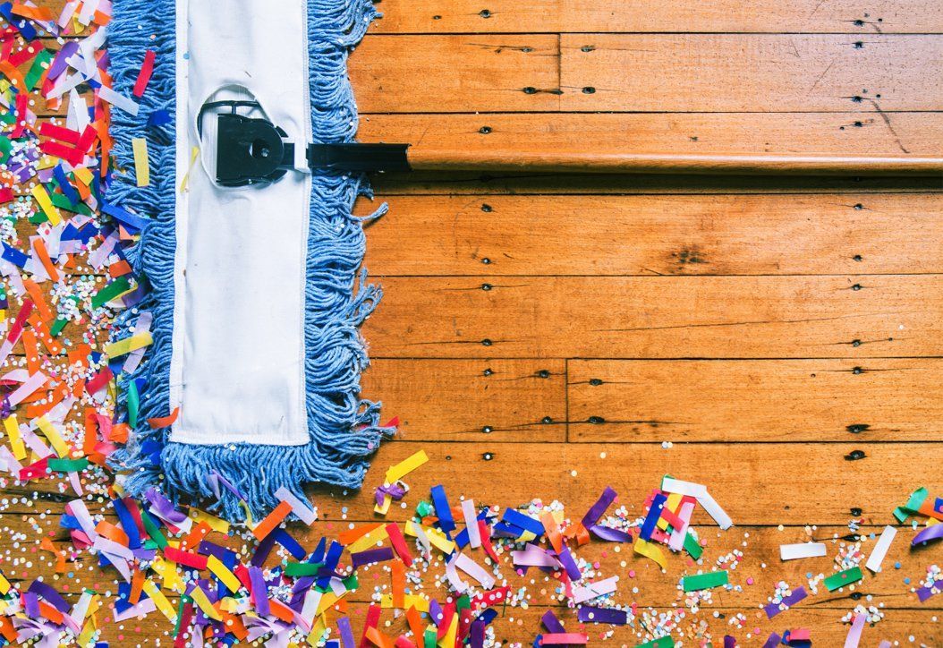 A big mop cleaning out confetti on the floor