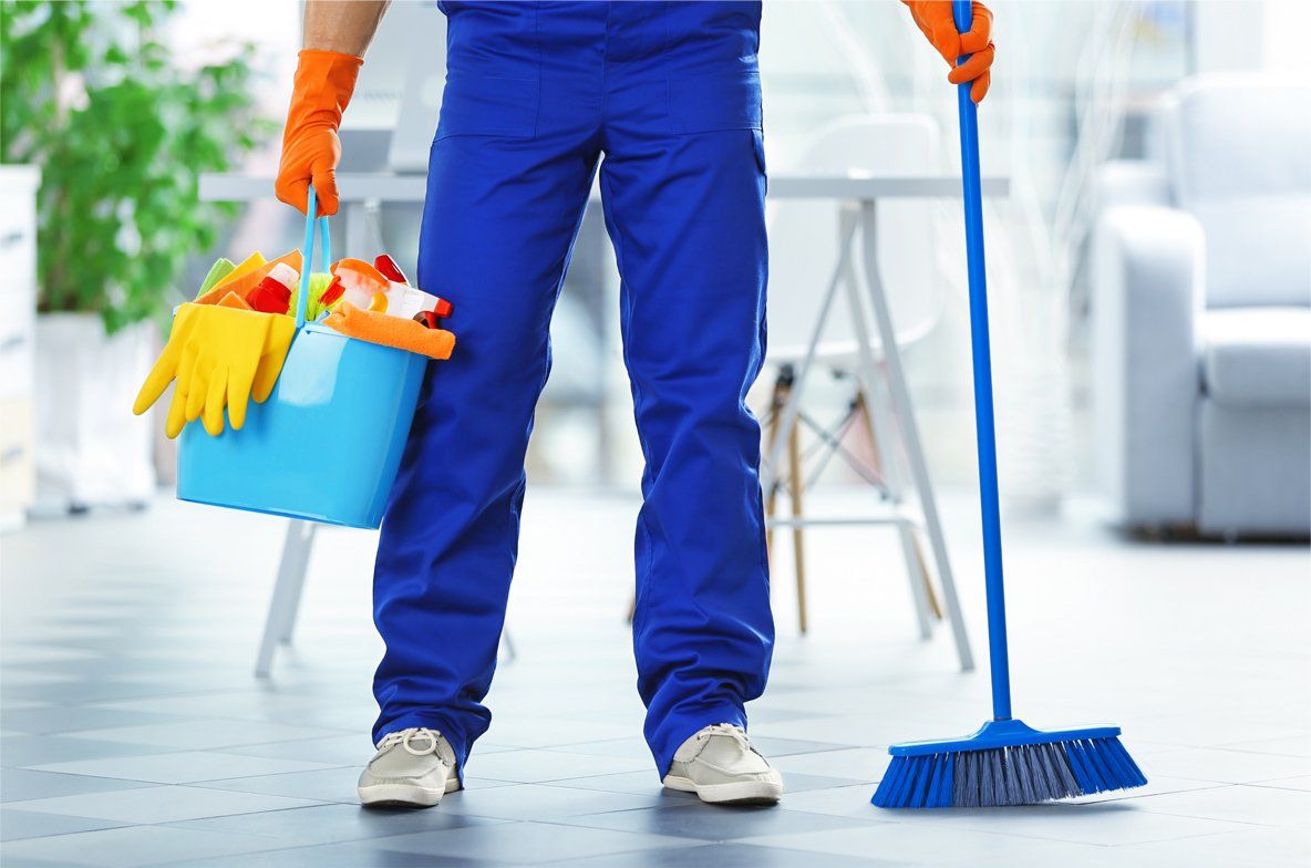 A professional cleaner holding equipment ready to clean office lobby
