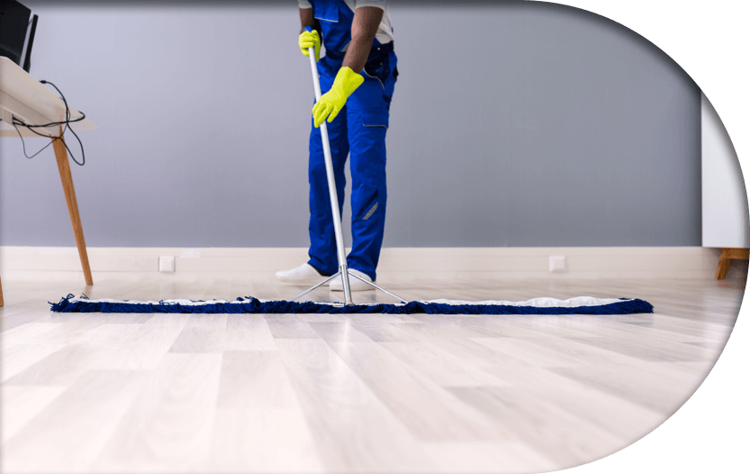 A professional cleaner using a big floor mop to thoroughly clean office