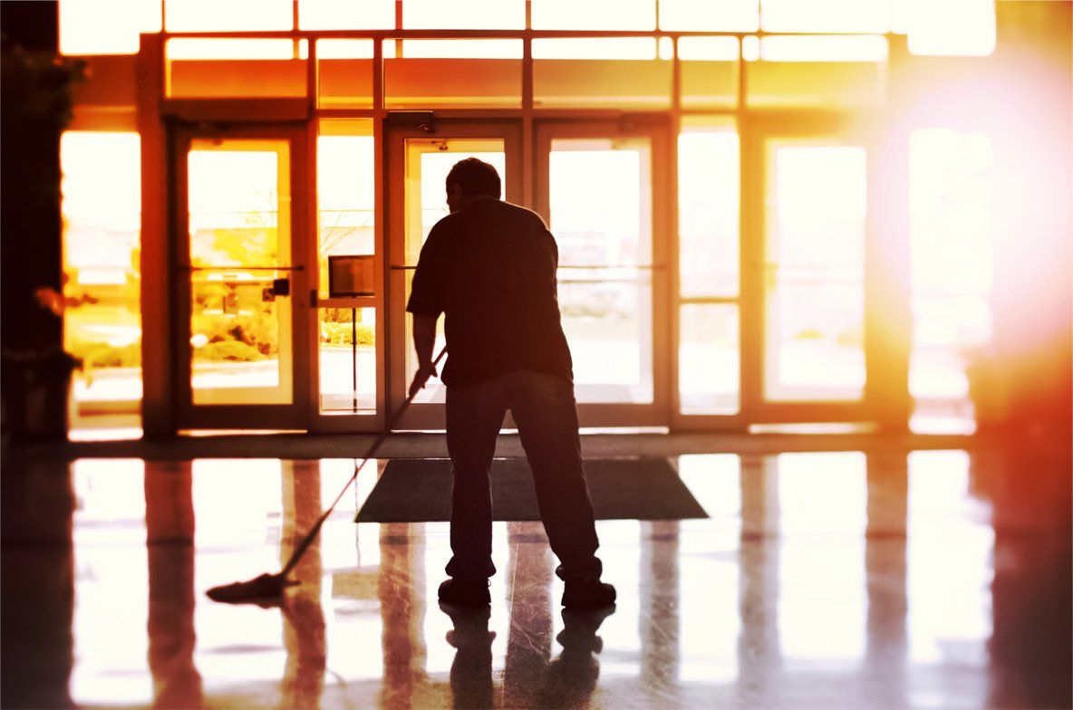 A professional cleaning a in a car dealership business