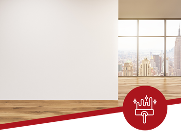 An empty room with a wooden floor and a large window.