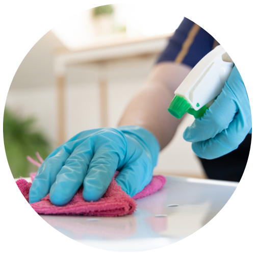 close up of school cleaner's hand wiping the table