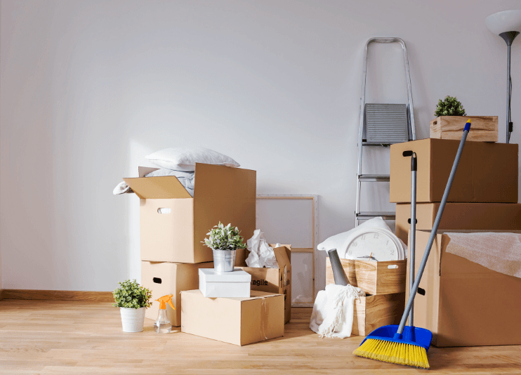 Empty room full of cardboard boxes and cleaning things for moving in