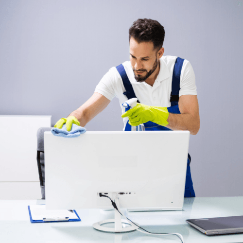 a man wiping computer screen