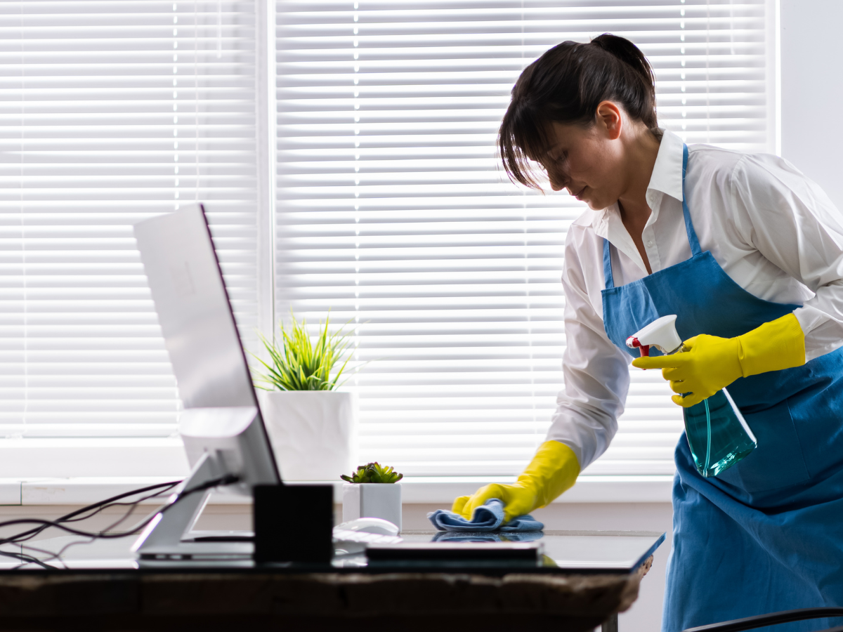 janitor cleaning the office desk