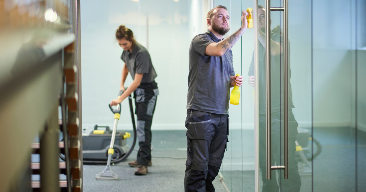 janitors wiping the glasses and mopping the floor