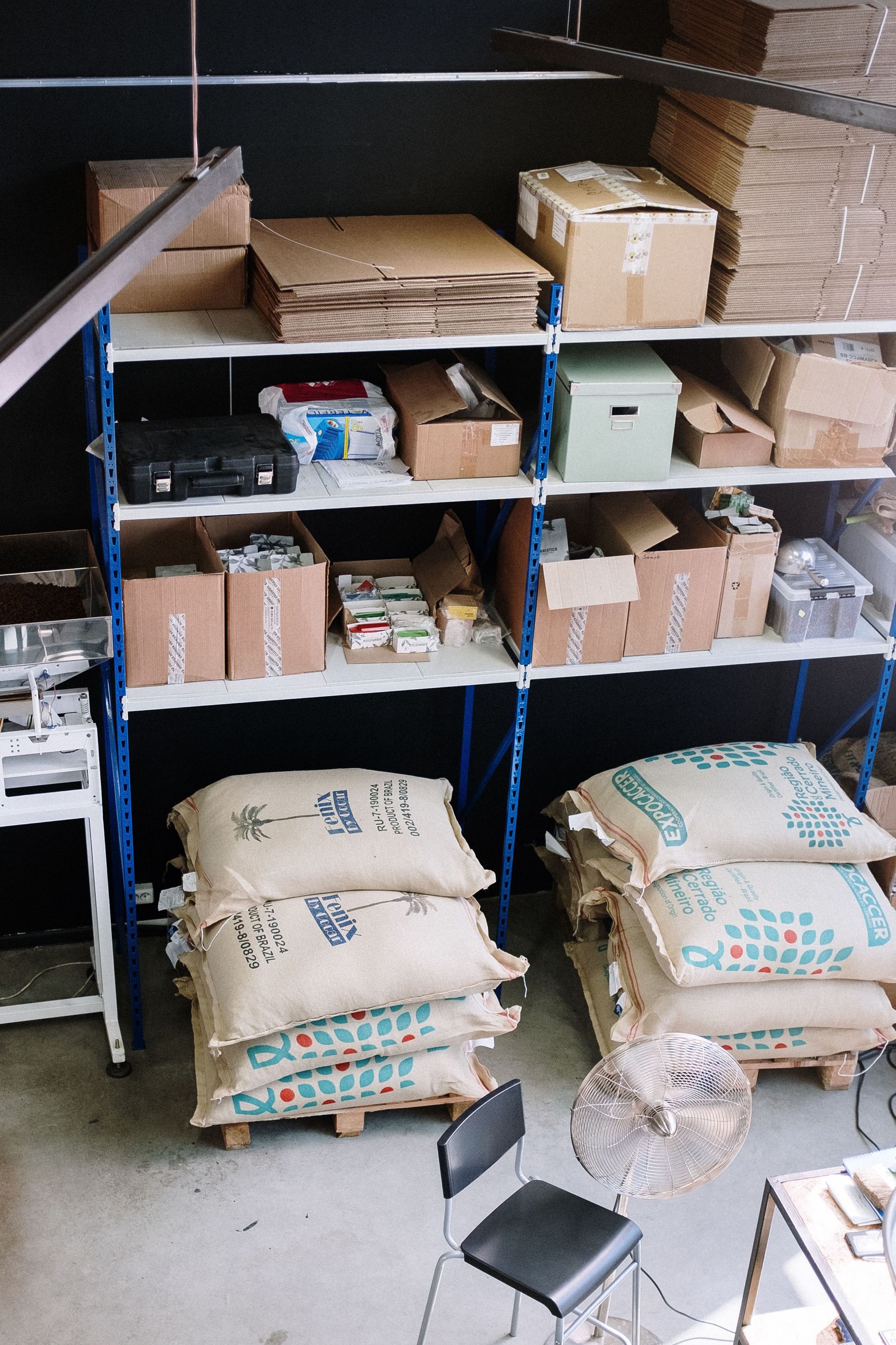 A warehouse shelf with lots of items stored on it.