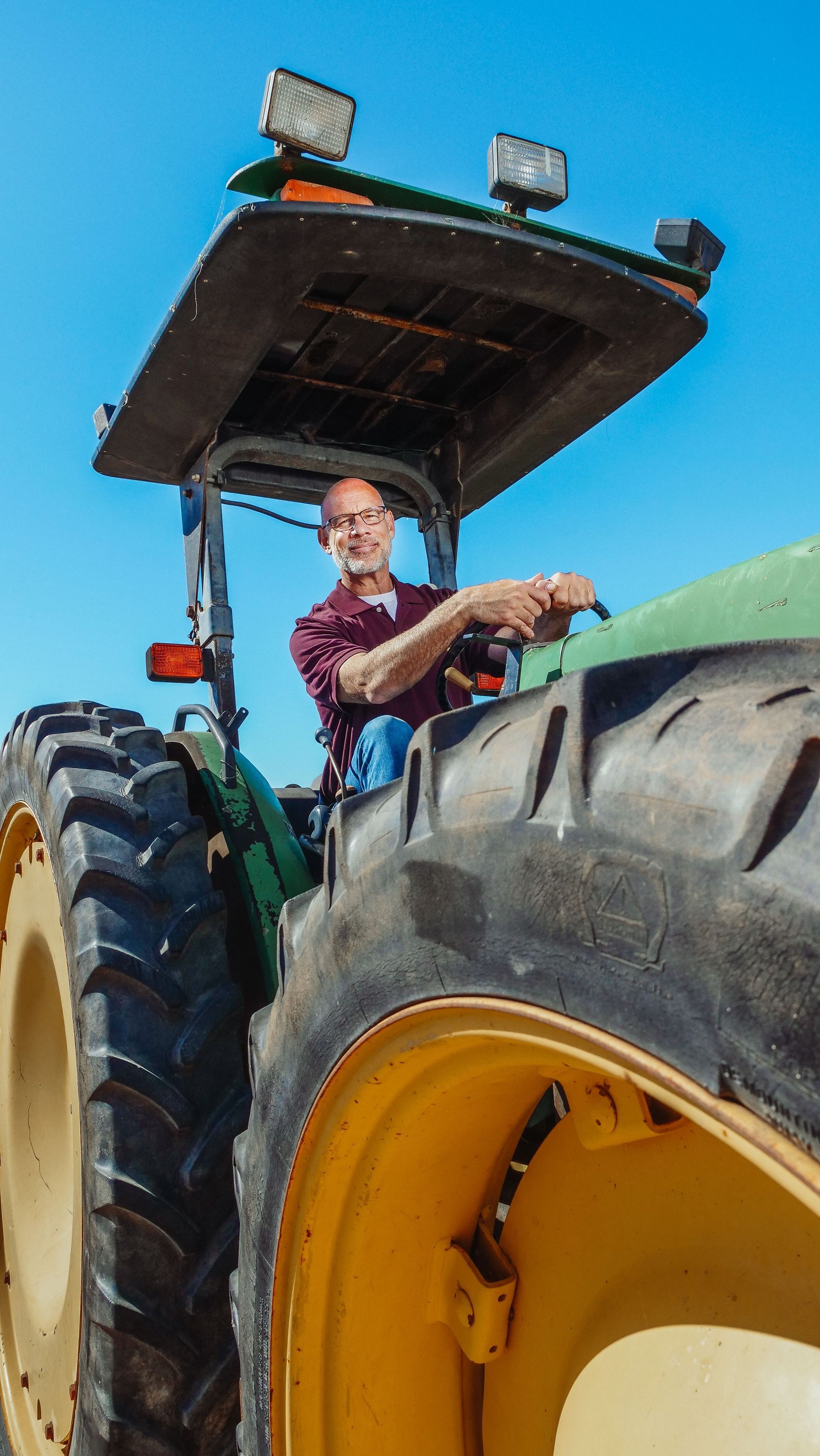 a farmer on his green tractor