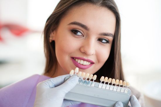 Girl Choosing Shade for Veneers