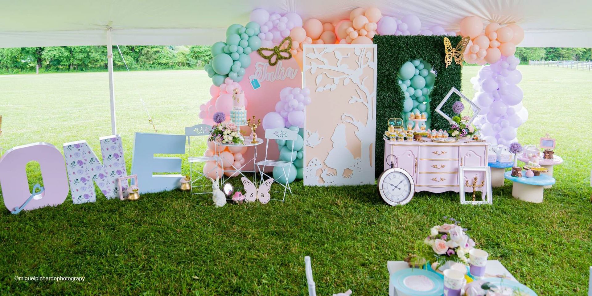 First birthday party with pastel balloons, decor, and the word 