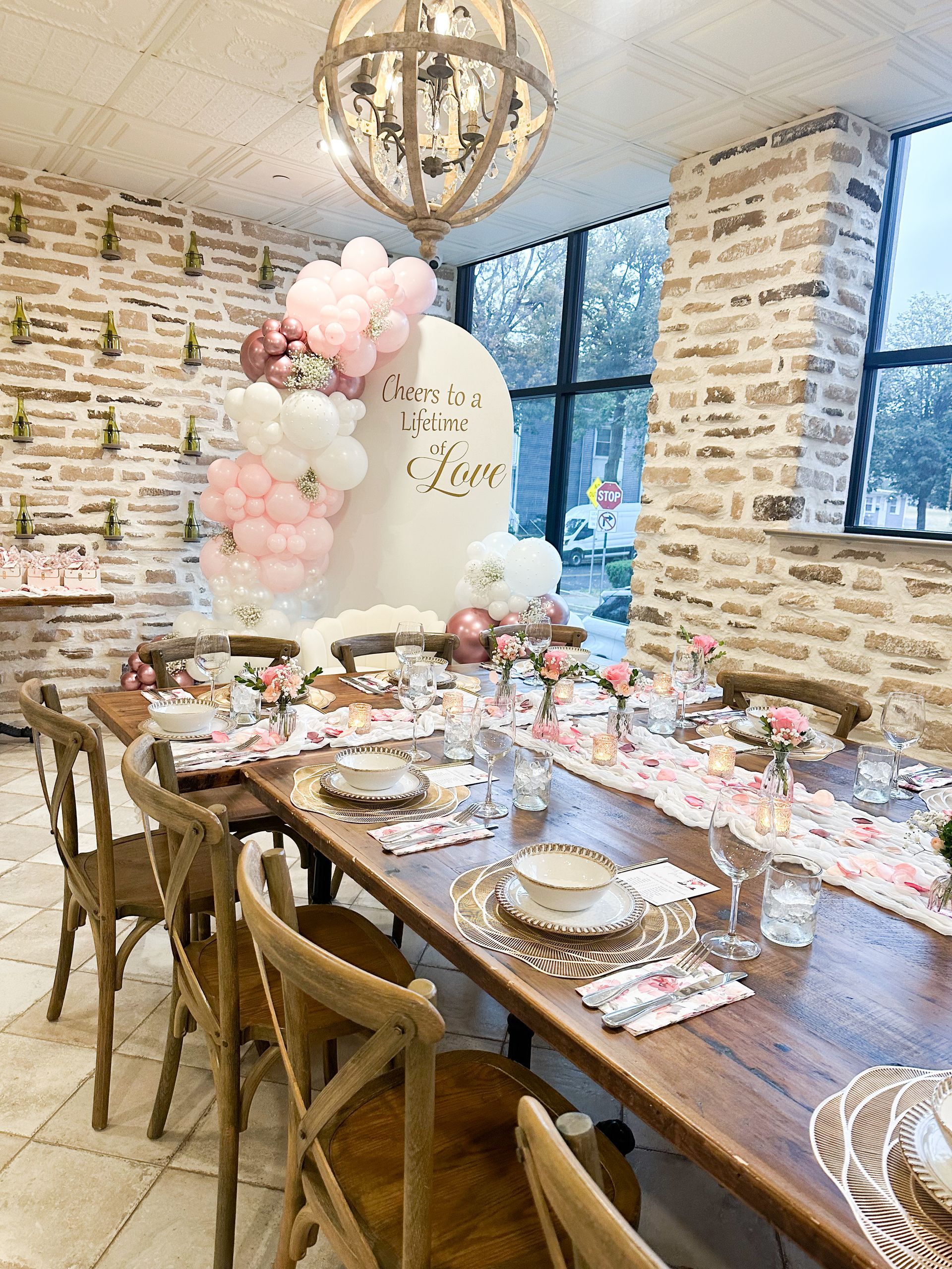 Elegant table setting with balloons and floral decor for a party.