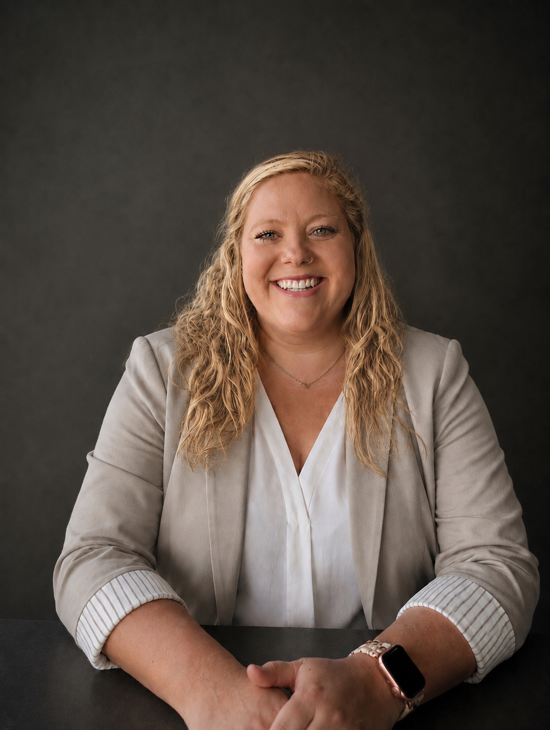 Smiling therapist, blonde hair, sitting