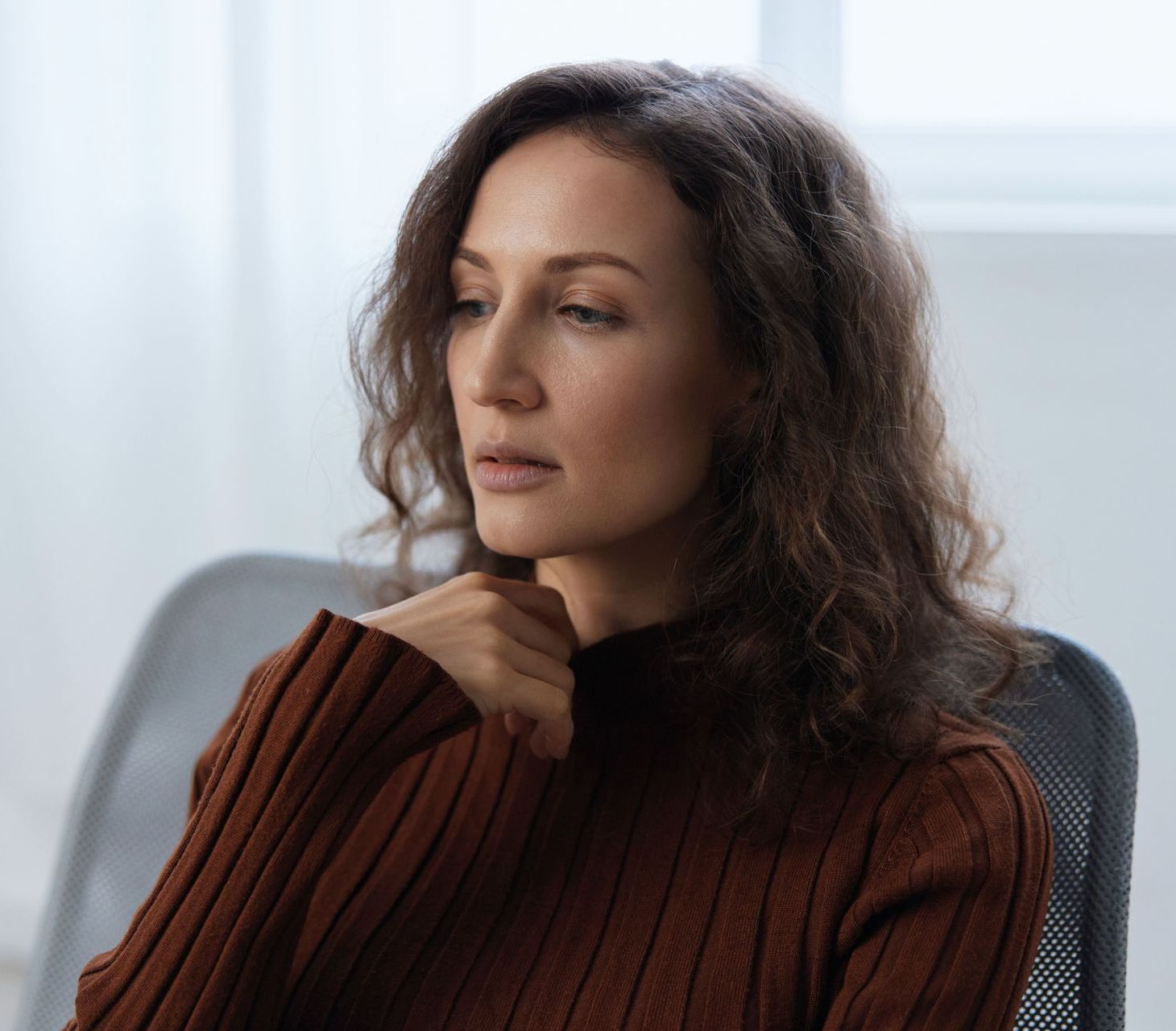 Woman looking tired and overwhelmed, representing undiagnosed trauma
