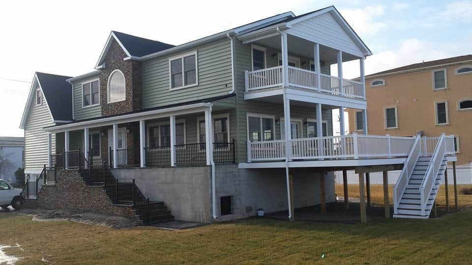 A large house with a large deck and stairs