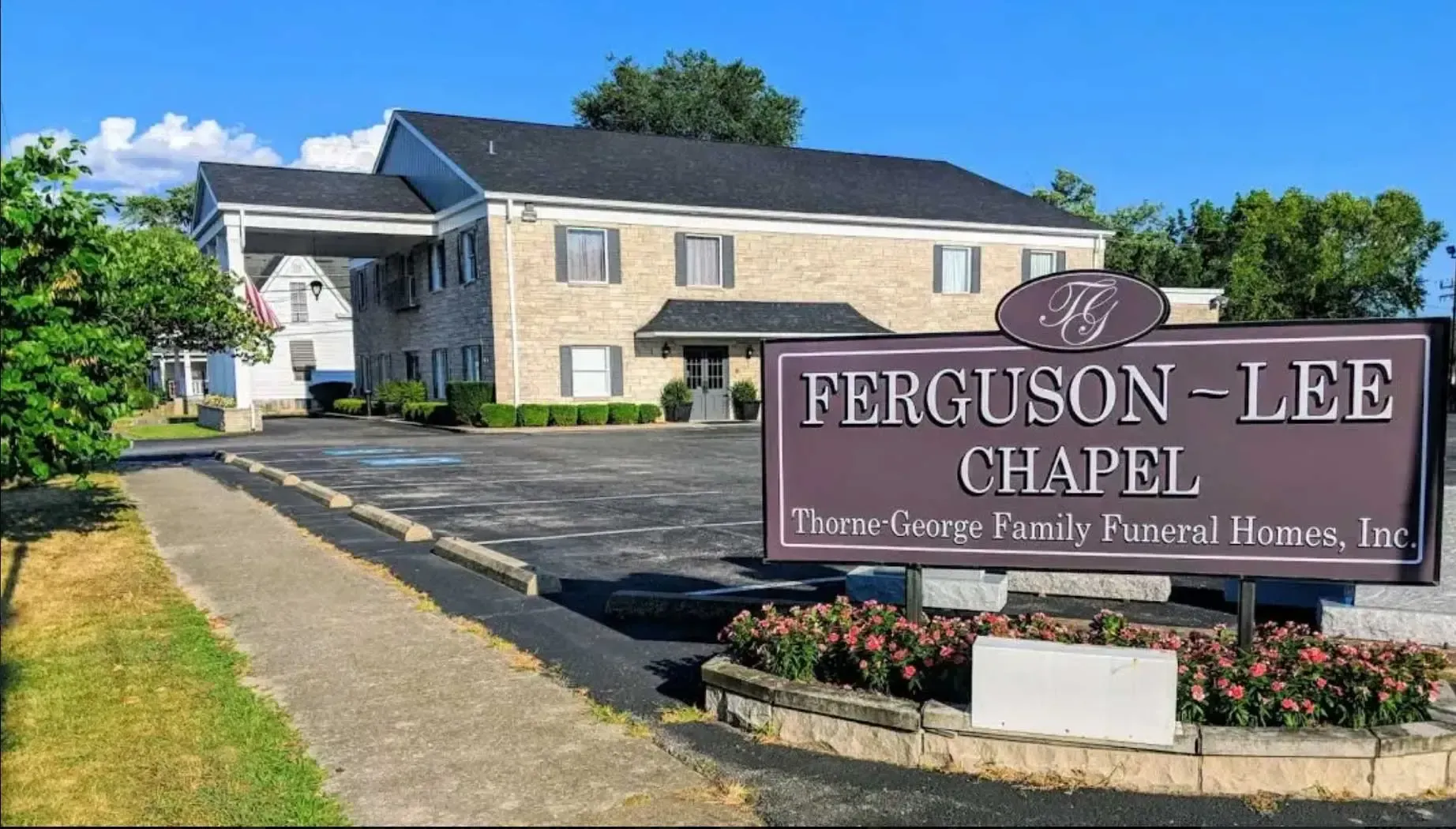 Ferguson-Lee Chapel sign in front of a beige building on a sunny day.