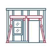 House exterior framed by red support braces, with a window and open doorway under construction.