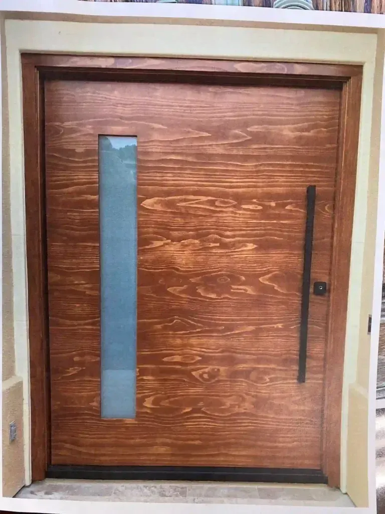 Wooden front door with a narrow vertical glass panel and long black handle.