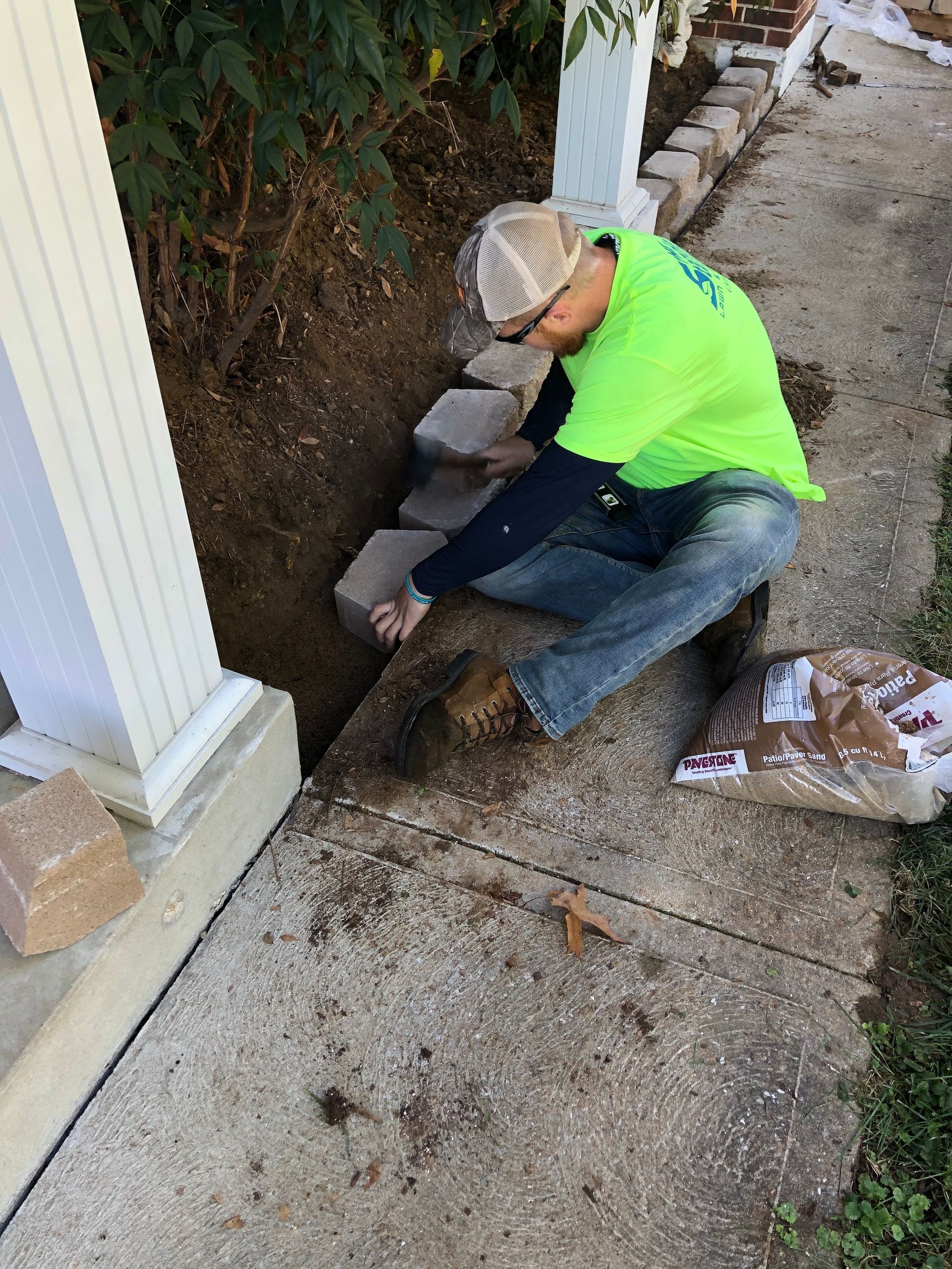 Person installing a retaining wall.