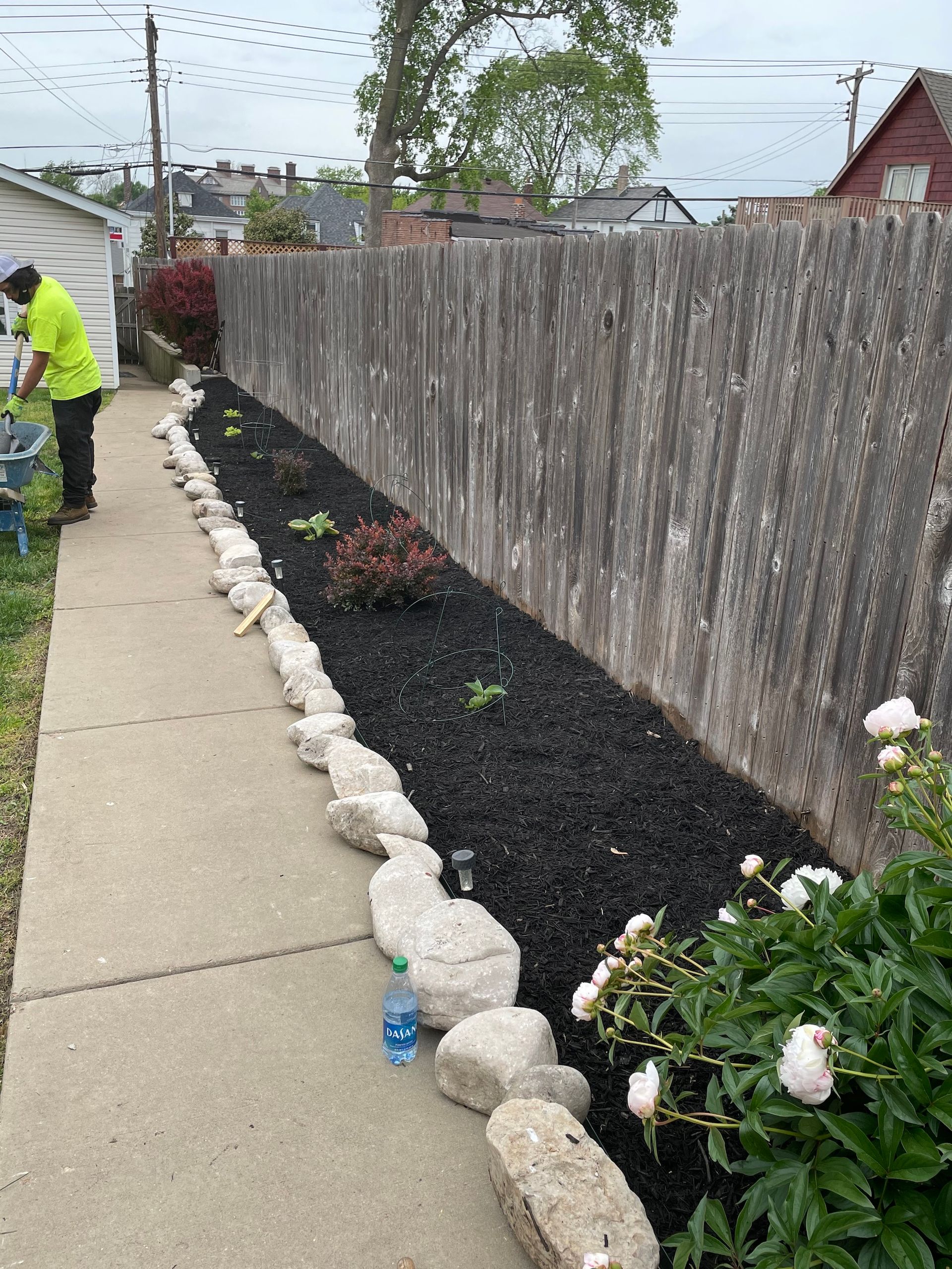 A garden bed with newly installed mulch and plants.