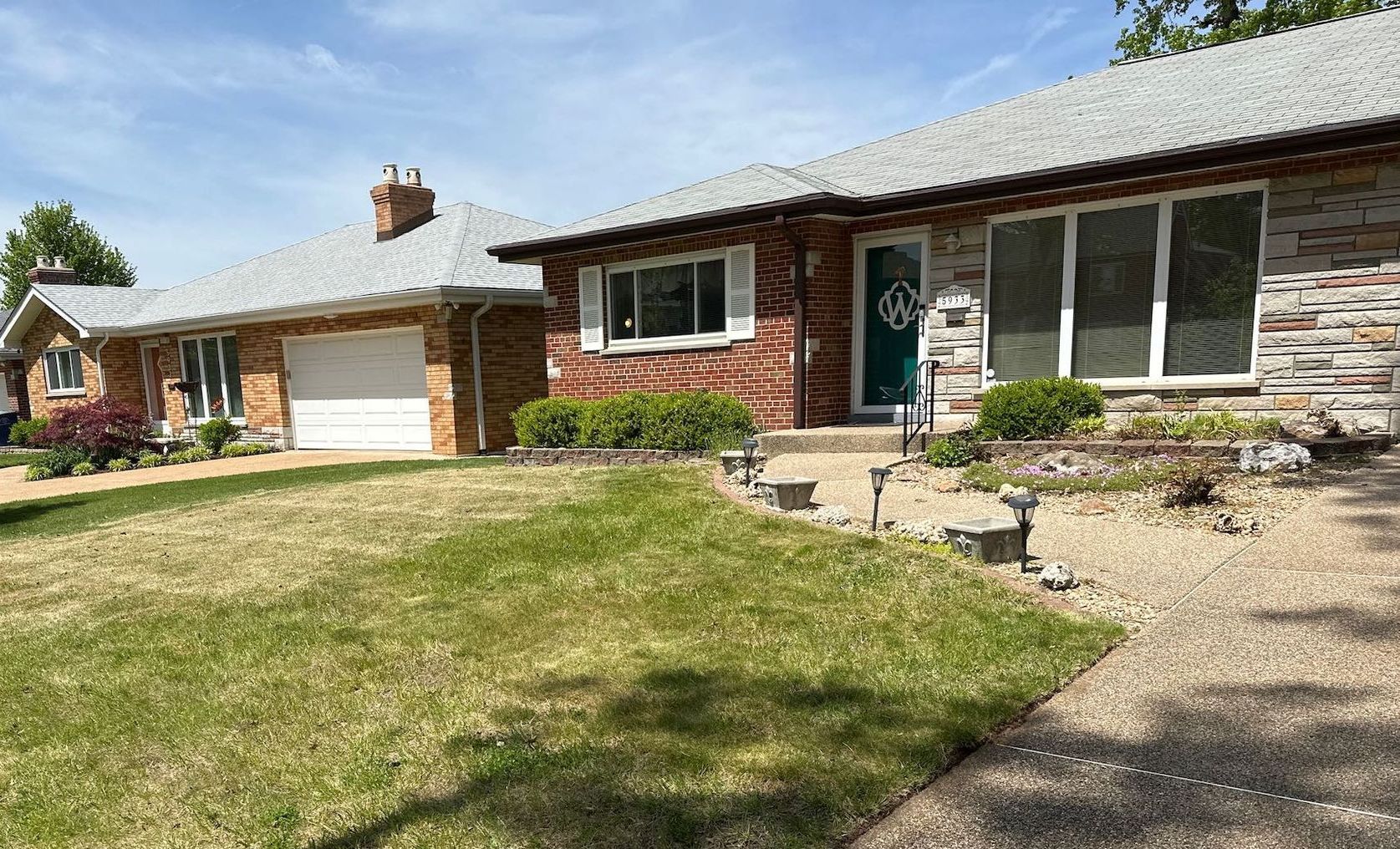 A house  with a large lawn in front of it.