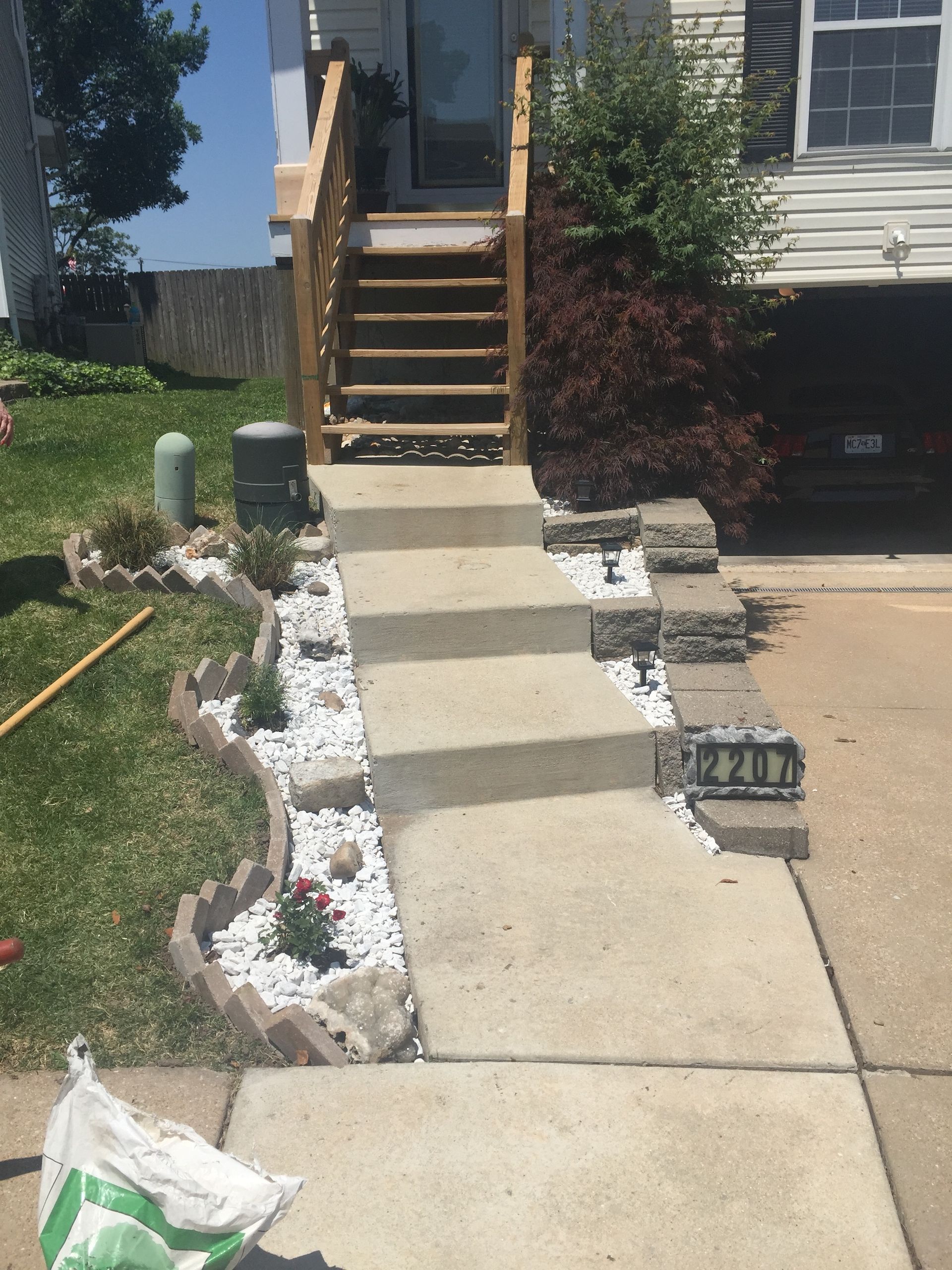 Rock bed with border along stairway steps.