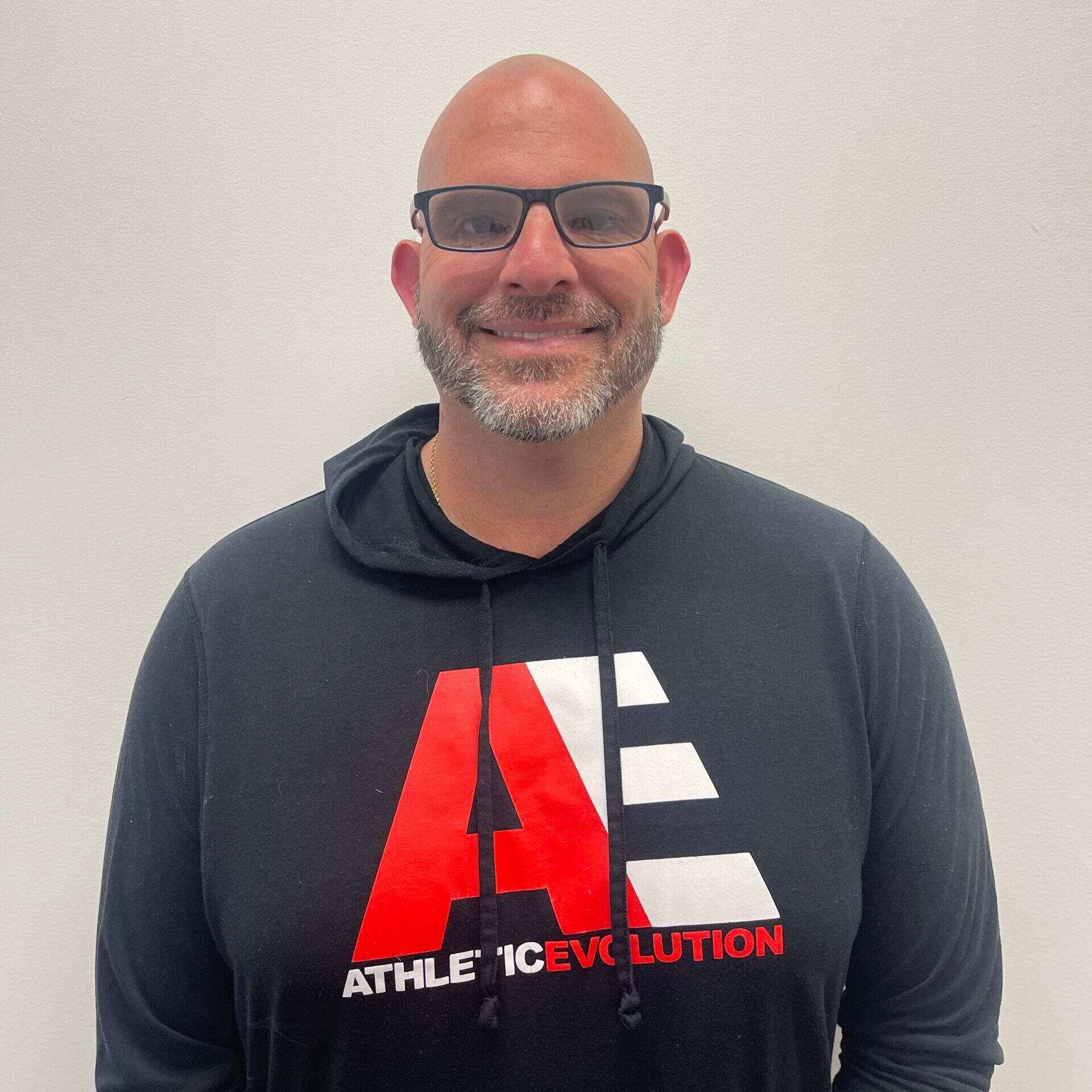 A man wearing a black shirt that says athletic evolution