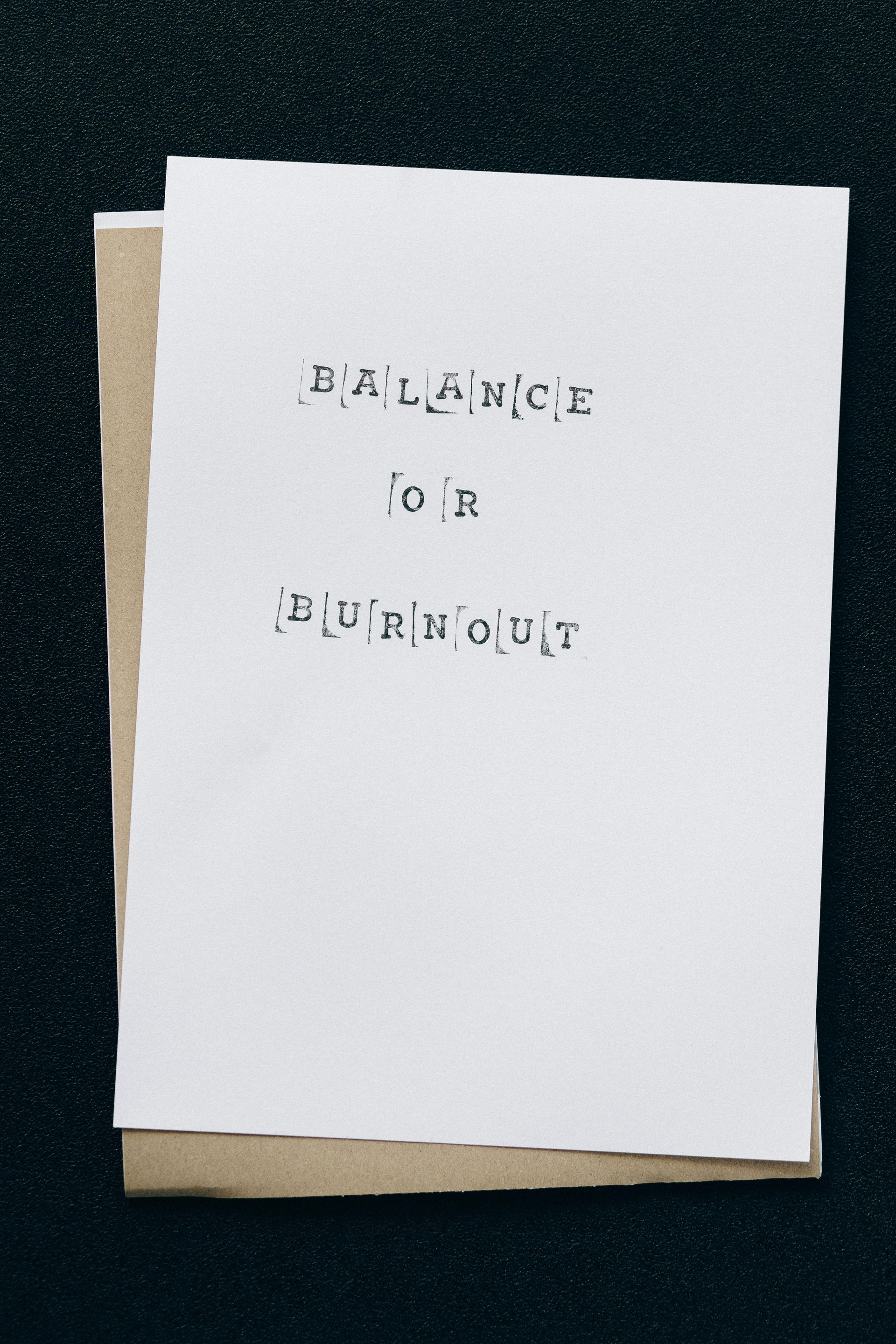 A piece of paper that says balance or burnout on it