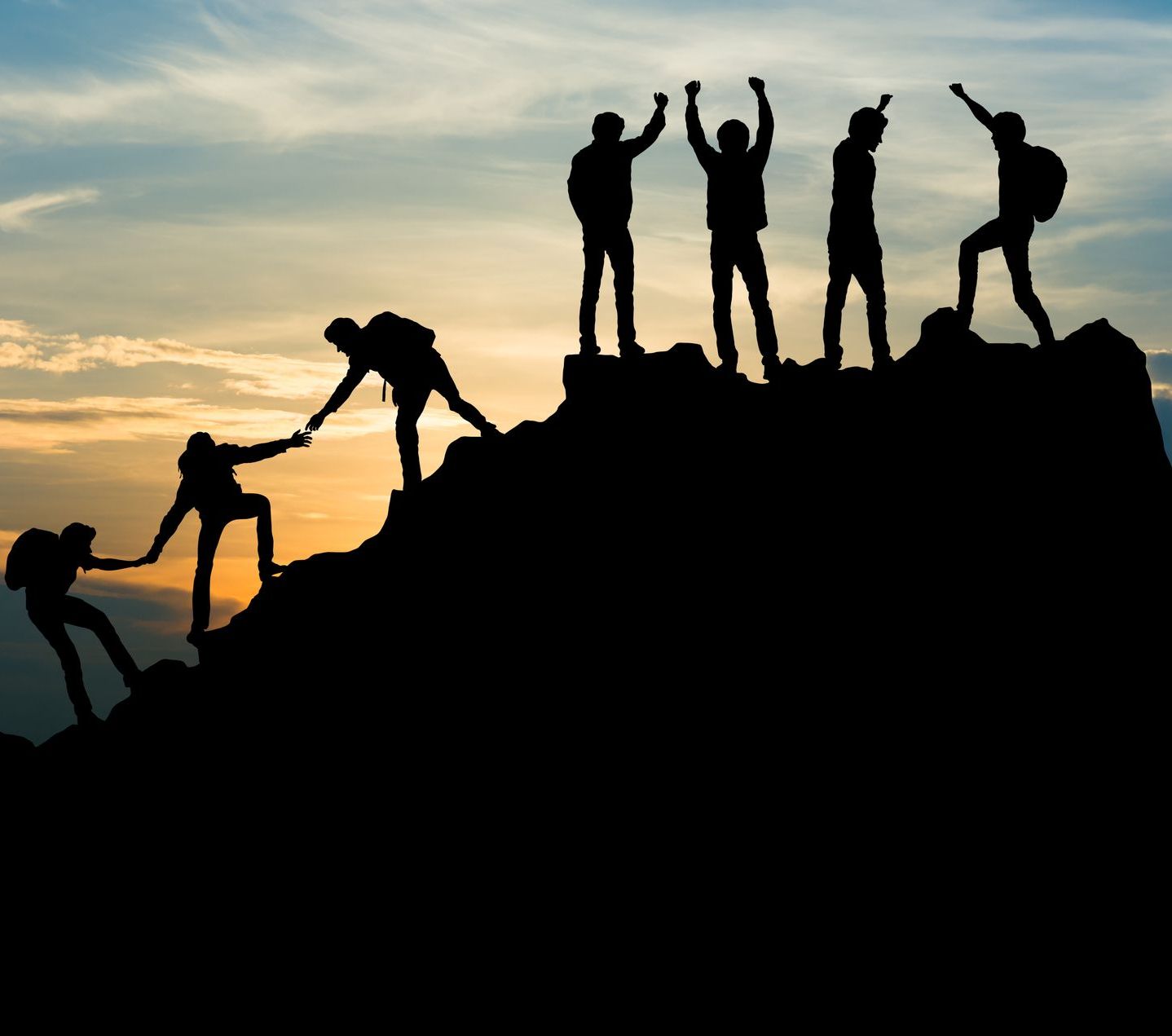 A group of people are standing on top of a mountain.