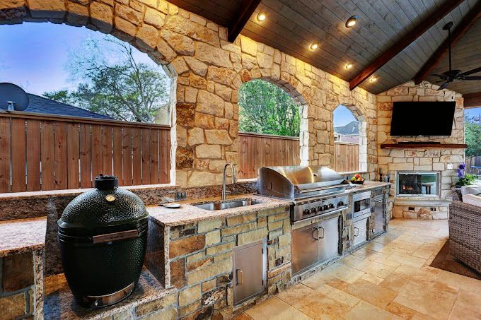 There is a large green egg grill in the middle of the kitchen.
