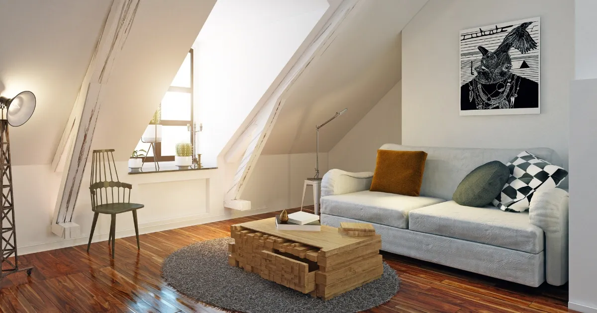 A modern attic living room with angled ceilings, a stylish sofa, and warm wood floors, for smart attic loft conversion ideas