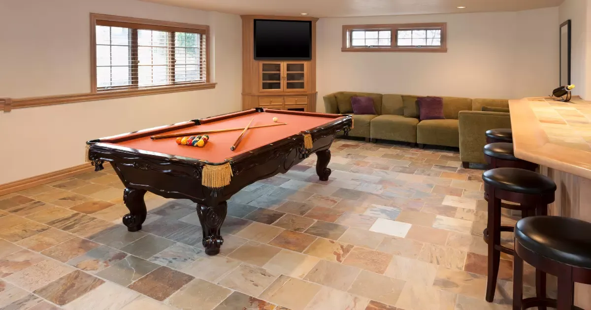 Basement game room with pool table, sectional sofa, bar seating, and stylish basement furniture for entertaining