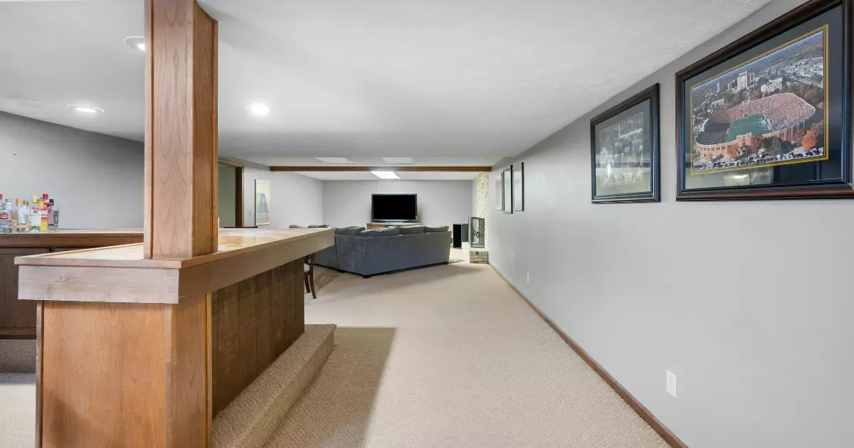 Basement bar and seating area showcasing custom basement finishing design