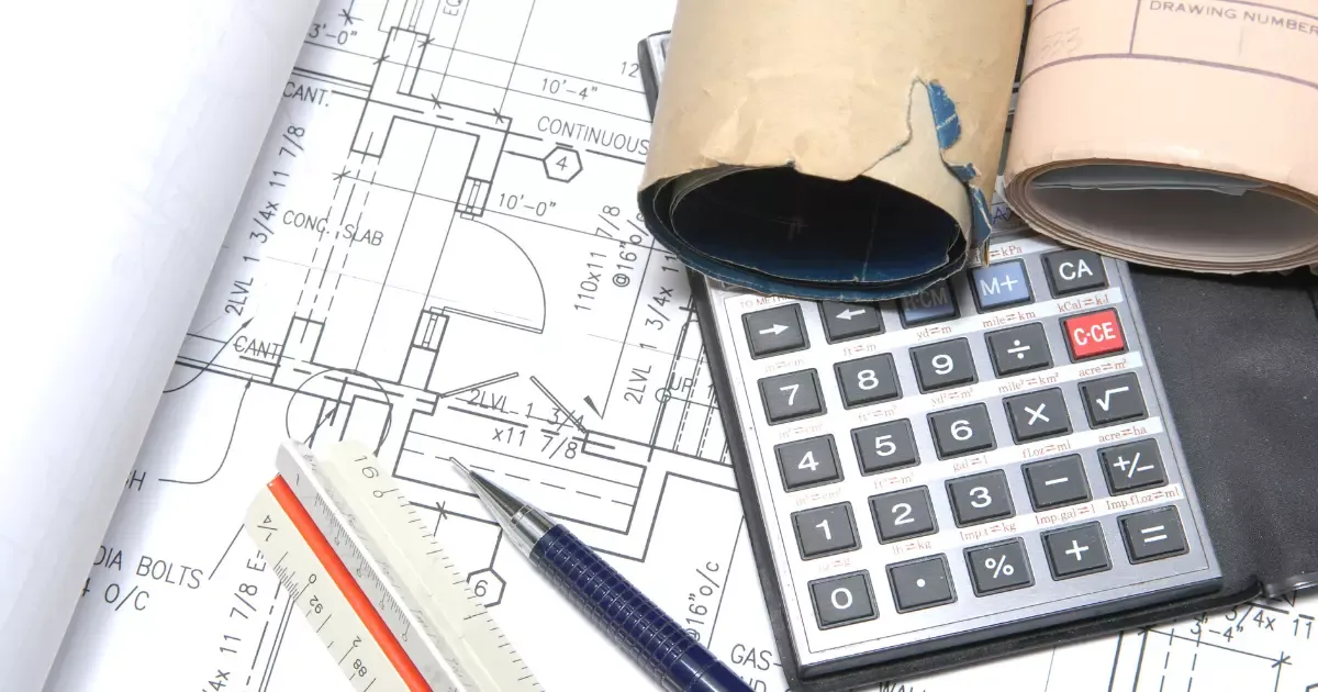 Blueprints, calculator, and tools used for planning basement finishing project