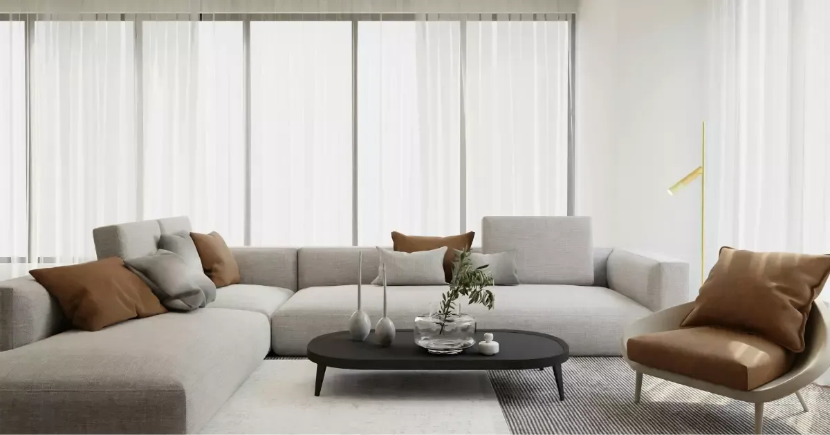 Bright open space with a large gray sectional sofa and black coffee table, reflecting trending living room design ideas