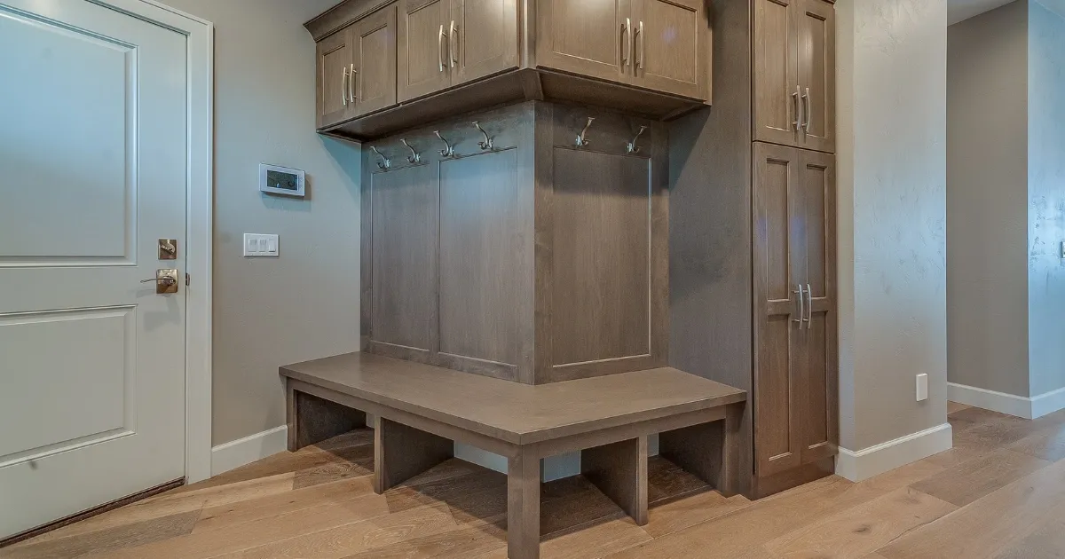 Built-in wood storage bench and cabinets showcasing practical mudroom ideas
