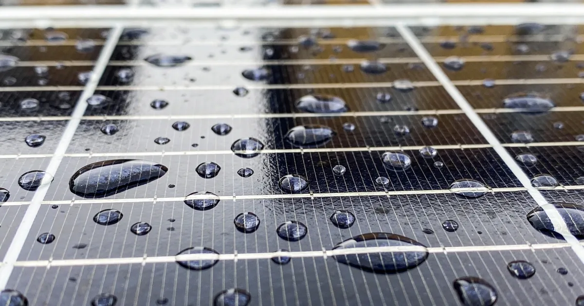 Water droplets on panel surface highlighting importance of cleaning solar panels