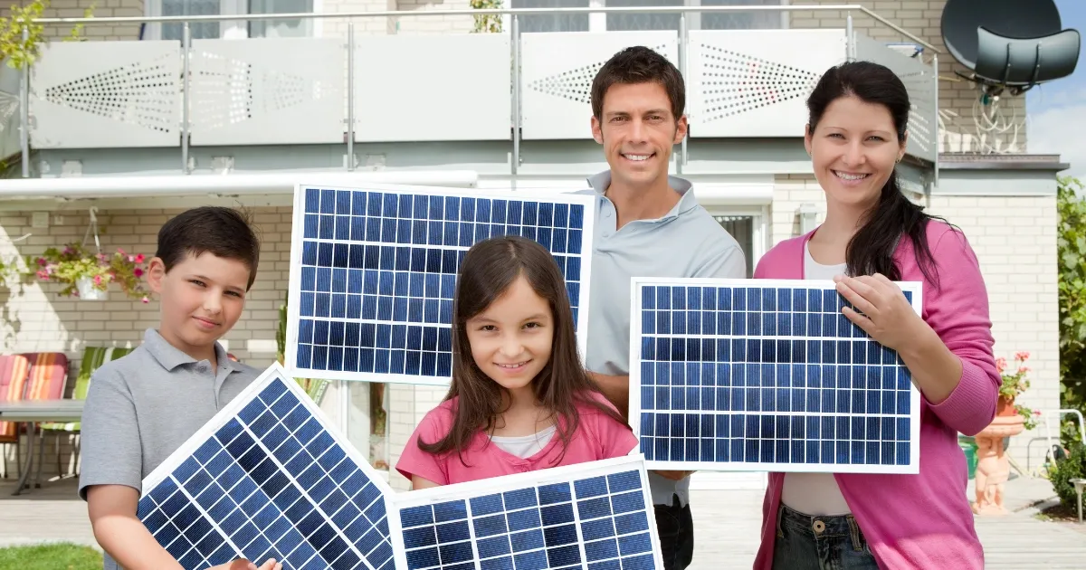 Family holding solar panels in front of their home while exploring a residential solar lease option