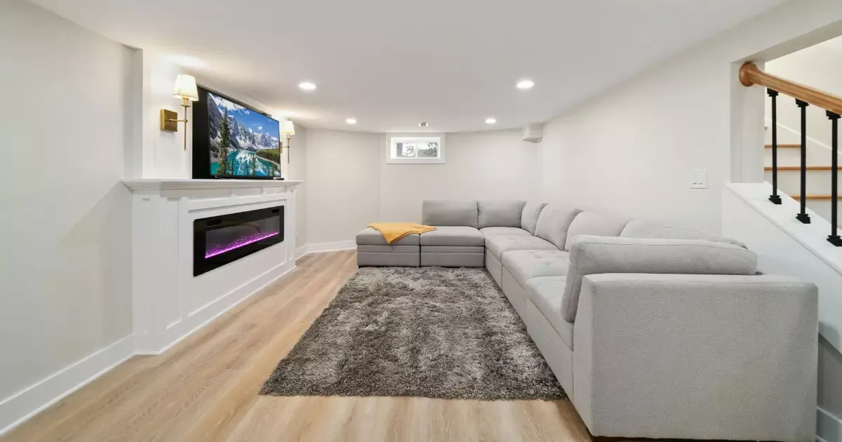 Modern living space with fireplace and TV after basement finishing