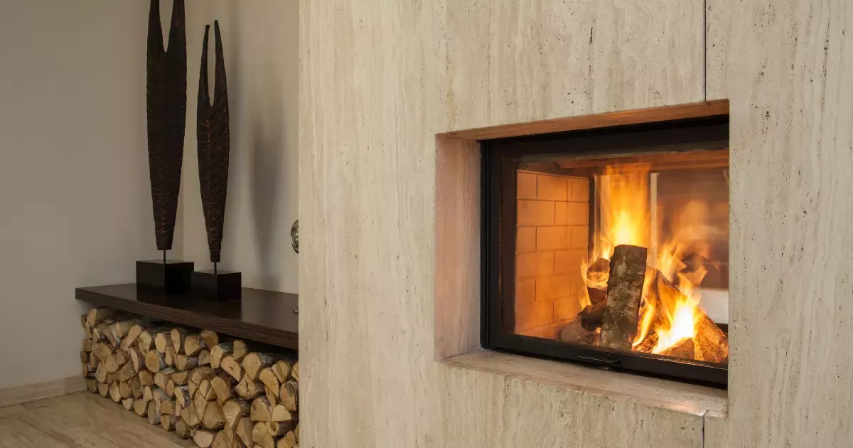 Modern basement fireplace ideas with glass insert, stacked firewood, and warm glowing flames