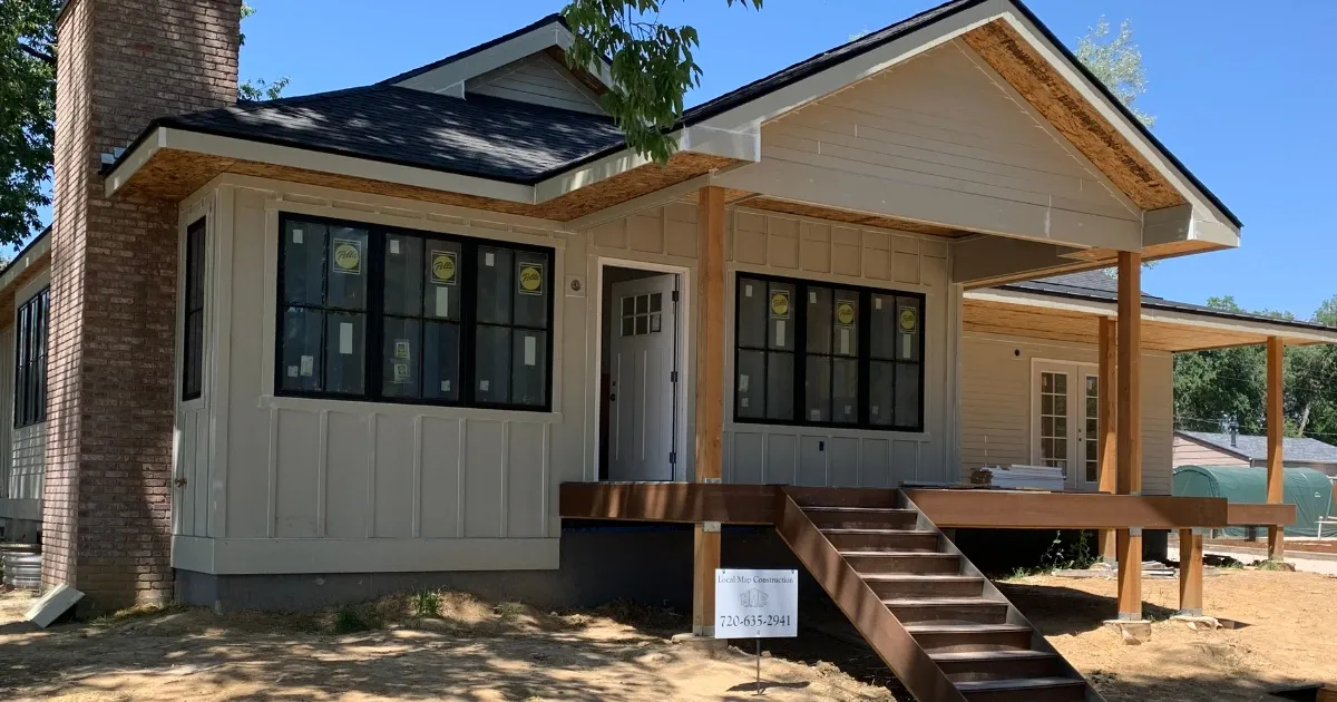 Front view of a modern house under construction showcasing progress in custom home building