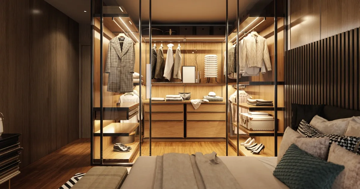 Glass-door walk-in closet with warm wood cabinetry and built-in storage showcasing modern bedroom closet ideas