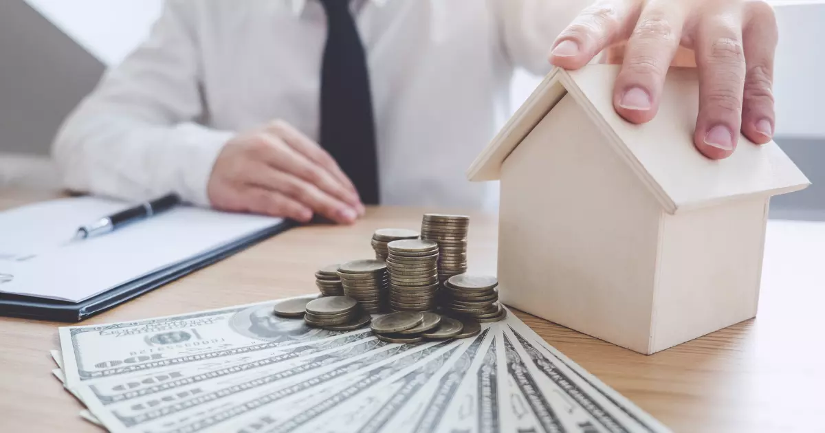 Homeowner reviewing budget with model house, cash, and coins, representing basement finishing costs and investment planning