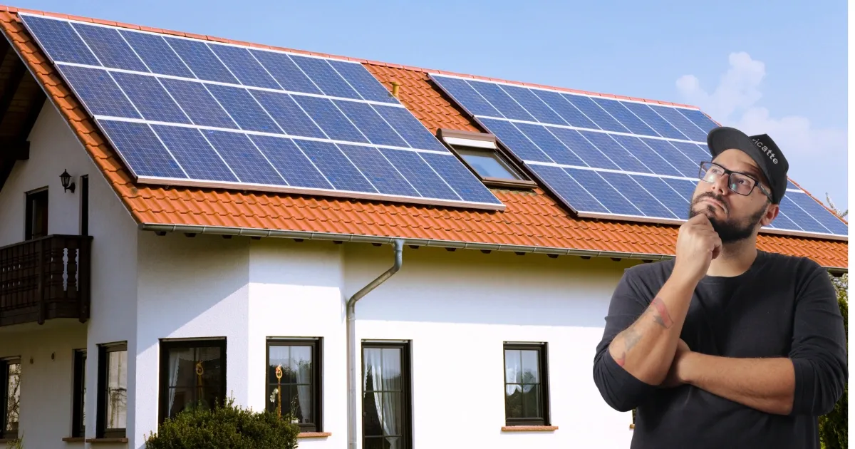 Homeowner looking at rooftop solar panels on a red tile roof, considering solar panels for energy savings